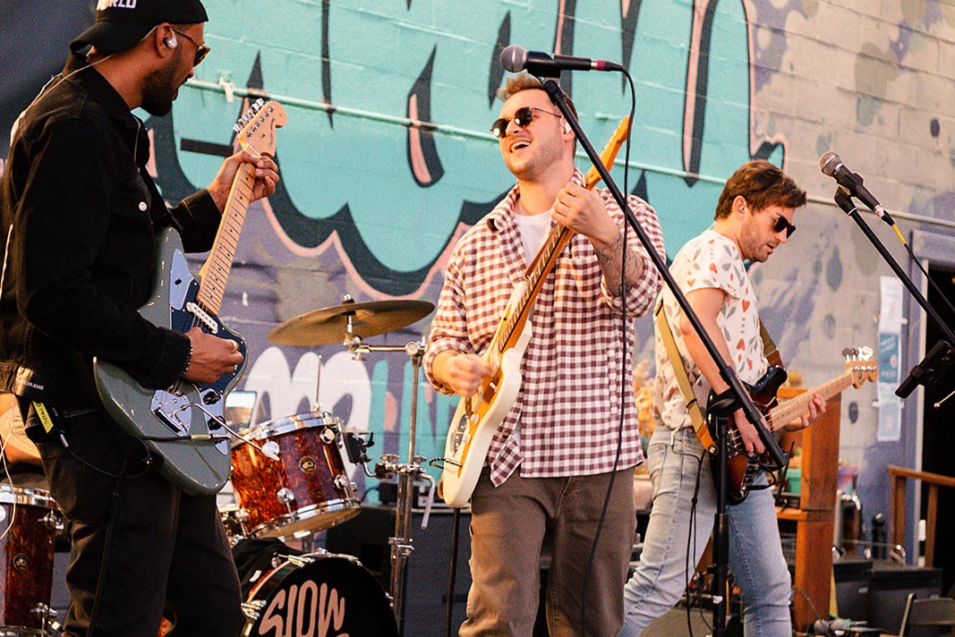 A band performing with a full drum kit