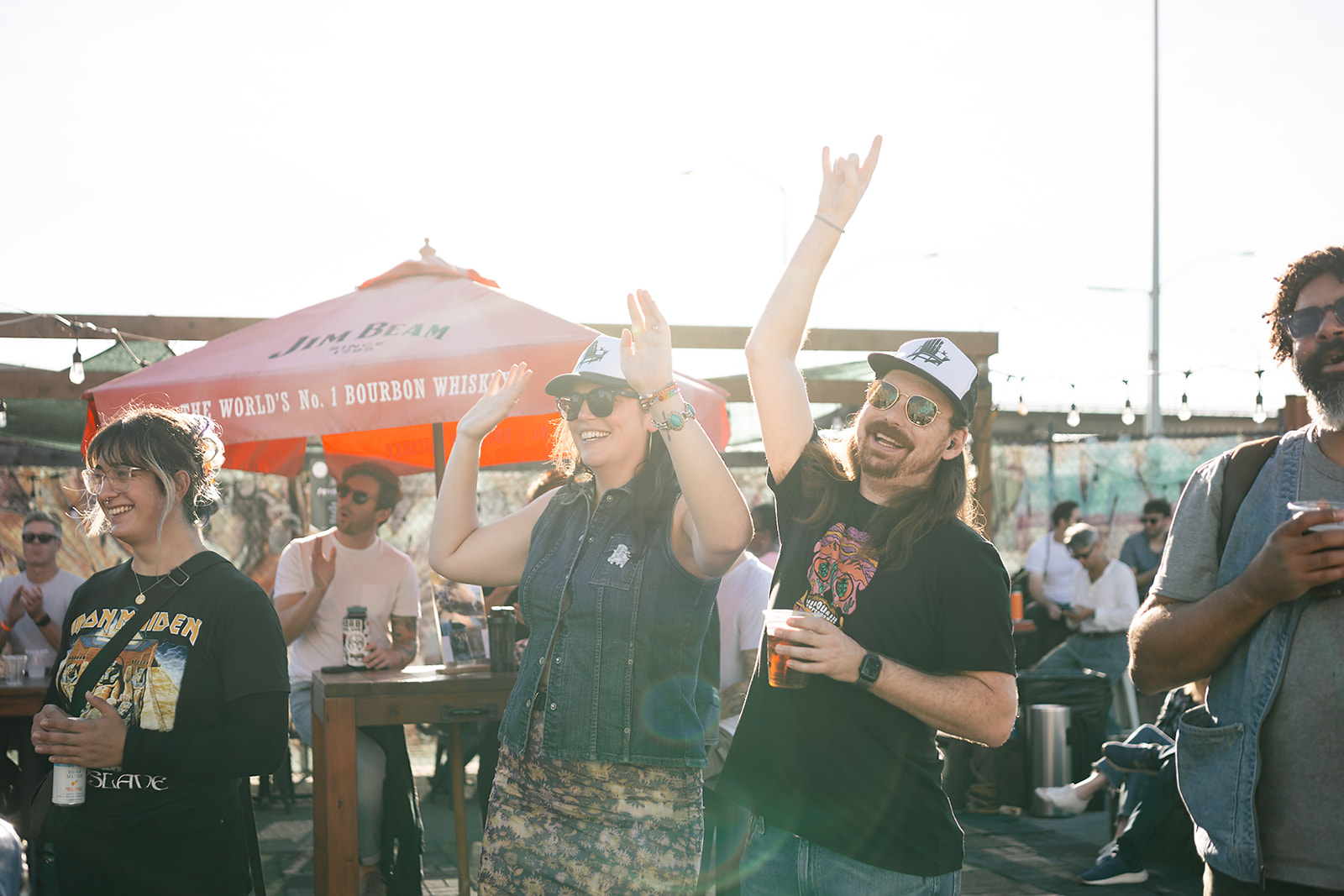 A crowd cheering with hands raised at a show