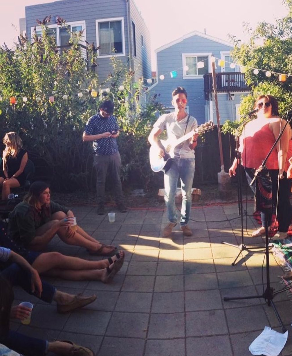 A three-piece band performing on the patio stage